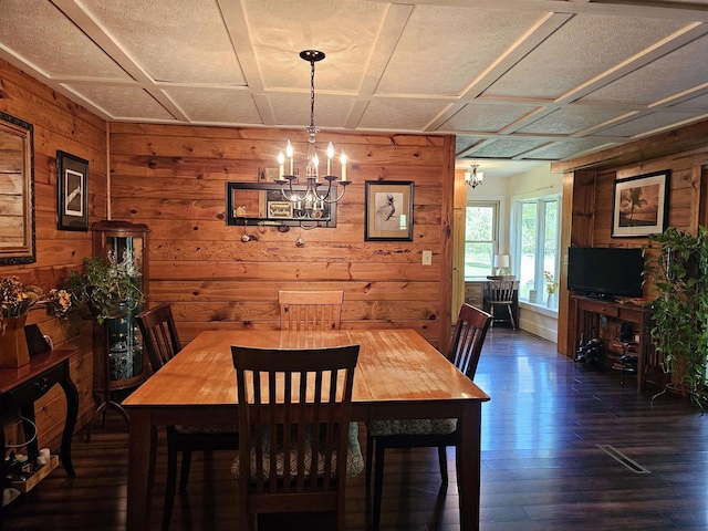 9388 Alpine Rd, Fremont, WI 54940 - dining area with wooden walls, a chandelier, and dark wood finished floors