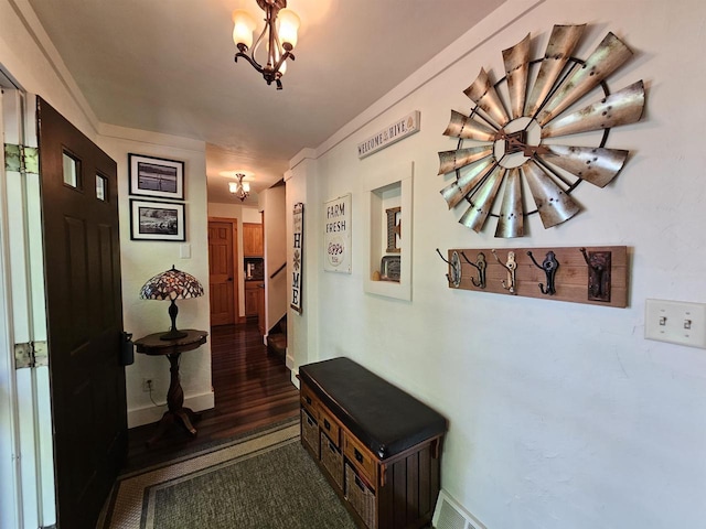 9388 Alpine Rd, Fremont, WI 54940 - hallway featuring a chandelier, wood finished floors, and baseboards
