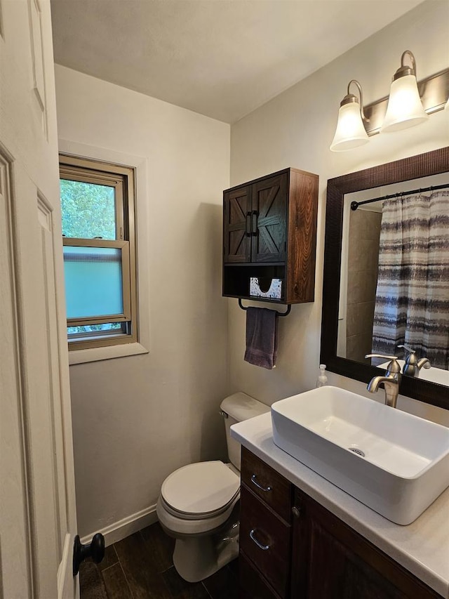 9388 Alpine Rd, Fremont, WI 54940 - full bathroom with toilet, vanity, wood finished floors, baseboards, and a shower with curtain
