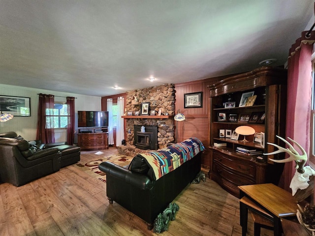 9388 Alpine Rd, Fremont, WI 54940 - living room featuring hardwood / wood-style floors, a wood stove, and wood walls