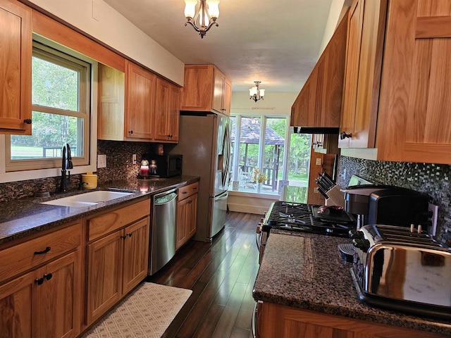 9388 Alpine Rd, Fremont, WI 54940 - kitchen featuring stainless steel appliances, a sink, a chandelier, and brown cabinets
