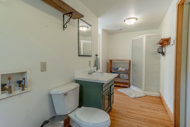 17785 Circle Dr, Boscobel, WI 53805 - full bath with vanity, a stall shower, wood finished floors, and toilet