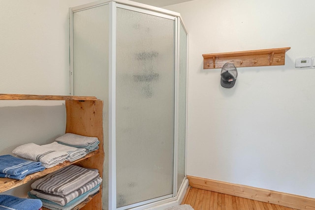 17785 Circle Dr, Boscobel, WI 53805 - bathroom featuring a stall shower, wood finished floors, and baseboards