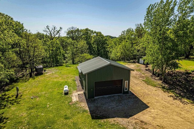 17785 Circle Dr, Boscobel, WI 53805 - view of grassy yard featuring an outbuilding, a garage, and a view of trees