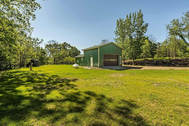 17785 Circle Dr, Boscobel, WI 53805 - view of grassy yard with an outbuilding, driveway, and a detached garage
