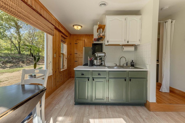 17785 Circle Dr, Boscobel, WI 53805 - kitchen featuring green cabinets, a sink, white cabinets, decorative backsplash, and light wood-style flooring