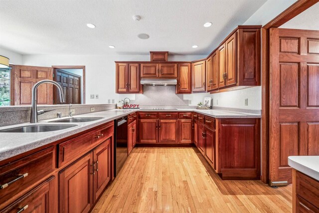 79 Oakridge Ct, Fond Du Lac, WI 54937 - kitchen featuring a sink, black dishwasher, light countertops, light wood-style floors, and under cabinet range hood