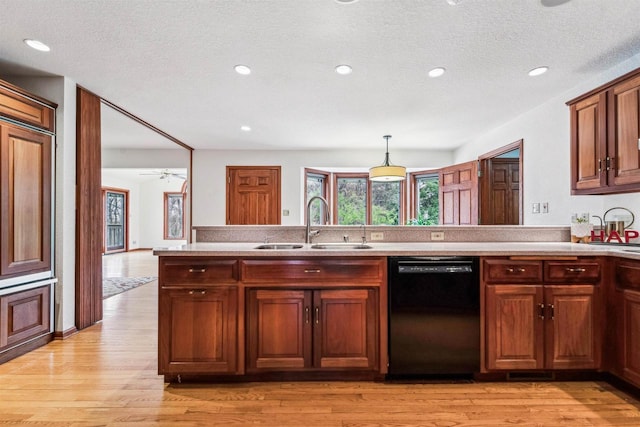 79 Oakridge Ct, Fond Du Lac, WI 54937 - kitchen with dishwasher, a sink, light countertops, a peninsula, and healthy amount of natural light
