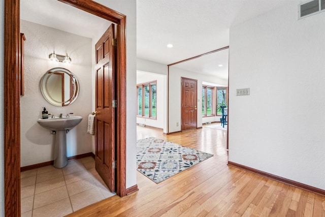 79 Oakridge Ct, Fond Du Lac, WI 54937 - bathroom featuring baseboards, wood finished floors, and recessed lighting
