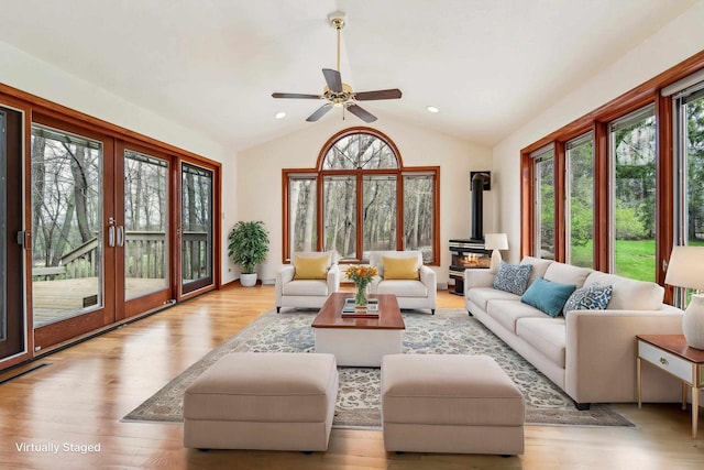 79 Oakridge Ct, Fond Du Lac, WI 54937 - living room featuring a wood stove, plenty of natural light, wood finished floors, vaulted ceiling, and ceiling fan