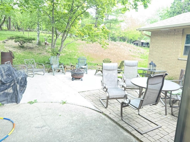 1306 Grandview Ave, Oconomowoc, WI 53066 - view of patio featuring a fire pit and outdoor dining space