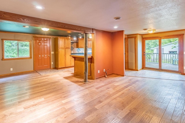 W3703 Scotch Coulee Rd, West Salem, WI 54669 - unfurnished living room featuring light wood-type flooring, healthy amount of natural light, baseboards, and recessed lighting