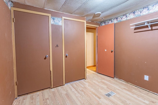 W3703 Scotch Coulee Rd, West Salem, WI 54669 - unfurnished bedroom with wood finished floors and multiple closets