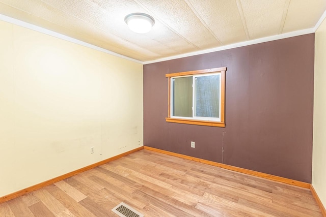W3703 Scotch Coulee Rd, West Salem, WI 54669 - unfurnished room featuring light wood finished floors, crown molding, and baseboards