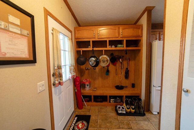 W7744 County Rd E, Westfield, WI 53964 - mudroom featuring crown molding, tile patterned flooring, and a textured ceiling