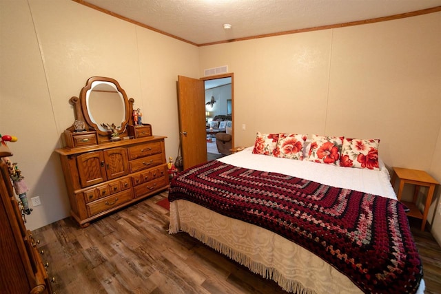 W7744 County Rd E, Westfield, WI 53964 - bedroom with wood finished floors, crown molding, and a textured ceiling