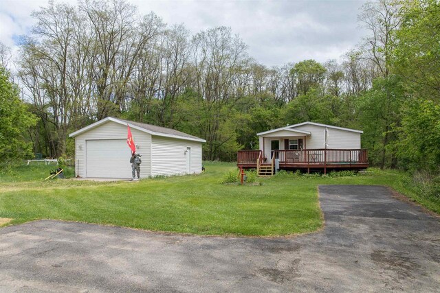 W7744 County Rd E, Westfield, WI 53964 - view of front facade with a detached garage, a wooden deck, an outbuilding, and a front lawn