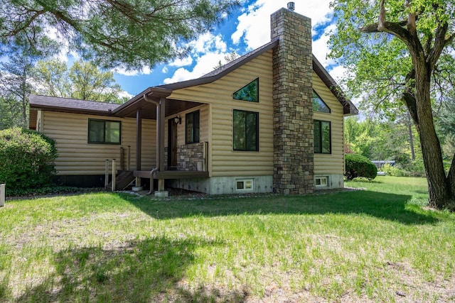 N12124 12th Ave, Necedah, WI 54646 - back of house with a yard, a chimney, log veneer siding, and a porch
