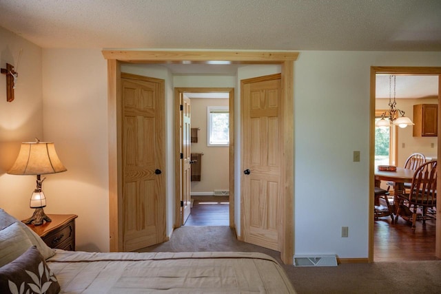 N12124 12th Ave, Necedah, WI 54646 - bedroom featuring carpet flooring, multiple windows, a chandelier, and baseboards