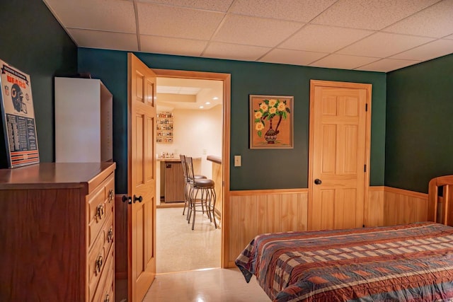 N12124 12th Ave, Necedah, WI 54646 - bedroom featuring a paneled ceiling, a wainscoted wall, and wooden walls