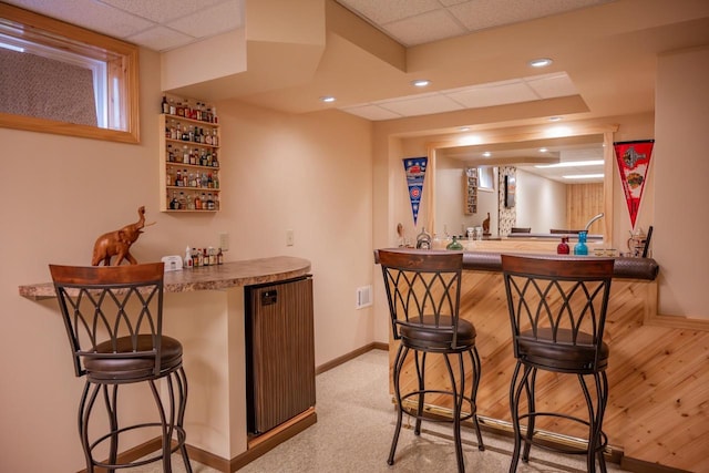N12124 12th Ave, Necedah, WI 54646 - indoor wet bar featuring baseboards, a paneled ceiling, recessed lighting, and light carpet
