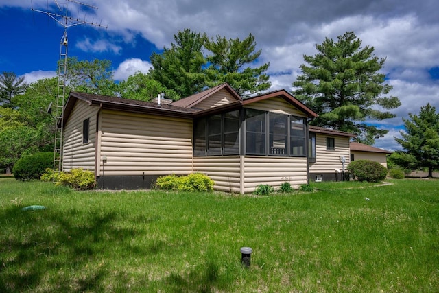N12124 12th Ave, Necedah, WI 54646 - view of front of home with a sunroom, log veneer siding, and a front lawn