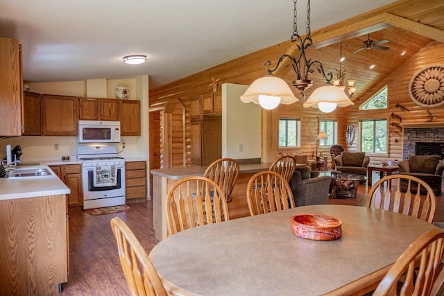 N12124 12th Ave, Necedah, WI 54646 - dining room with log walls, dark wood-style flooring, beam ceiling, ceiling fan, and high vaulted ceiling