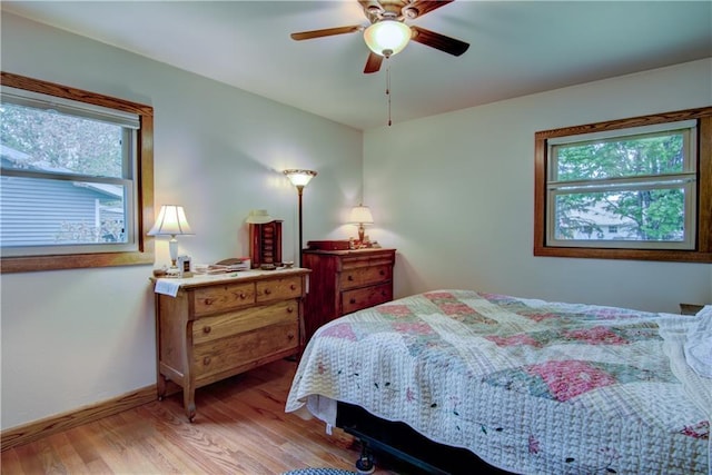 739 Veronica St, Chippewa Falls, WI 54729 - bedroom with multiple windows, light wood-style flooring, baseboards, and ceiling fan
