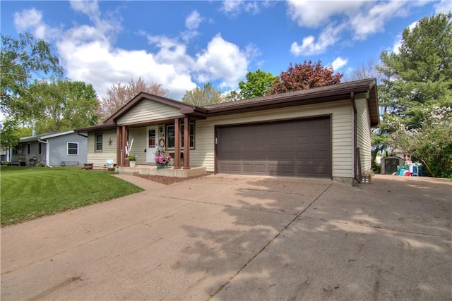 739 Veronica St, Chippewa Falls, WI 54729 - view of front of home featuring a porch, concrete driveway, a front lawn, and a garage