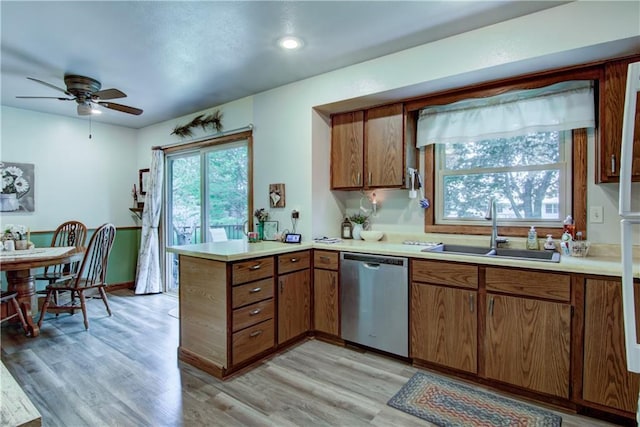 739 Veronica St, Chippewa Falls, WI 54729 - kitchen with dishwasher, a sink, a peninsula, brown cabinetry, and recessed lighting