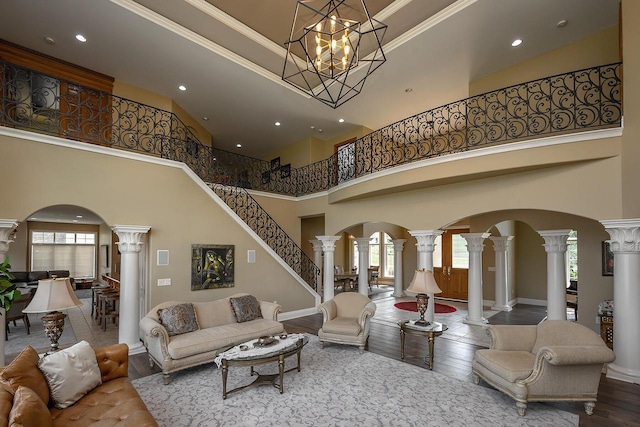 18290 Prairie Falcon Ln, Brookfield, WI 53045 - living area featuring ornate columns, arched walkways, a towering ceiling, plenty of natural light, and recessed lighting