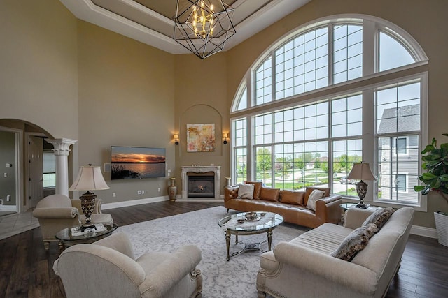 18290 Prairie Falcon Ln, Brookfield, WI 53045 - living room featuring a towering ceiling, healthy amount of natural light, wood finished floors, and baseboards