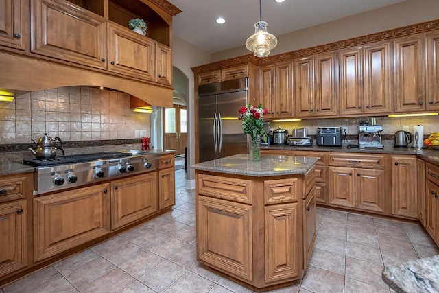 18290 Prairie Falcon Ln, Brookfield, WI 53045 - kitchen with appliances with stainless steel finishes, backsplash, brown cabinetry, and recessed lighting