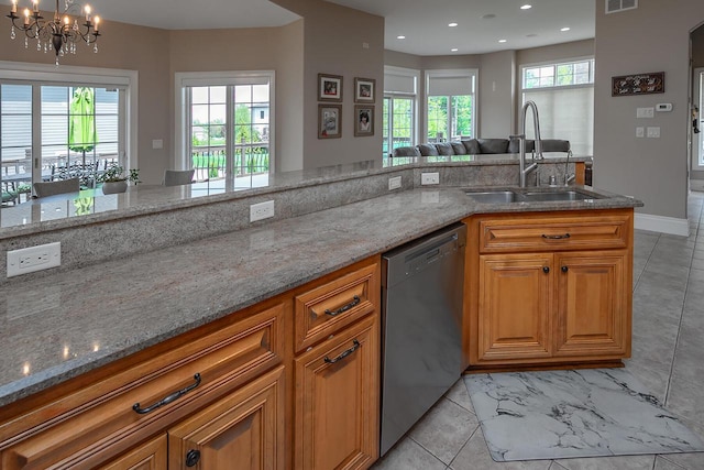 18290 Prairie Falcon Ln, Brookfield, WI 53045 - kitchen featuring dishwasher, a sink, open floor plan, light stone counters, and recessed lighting