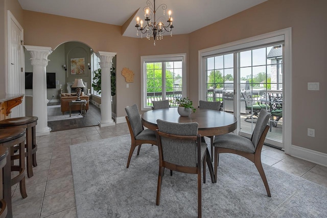 18290 Prairie Falcon Ln, Brookfield, WI 53045 - dining space featuring ornate columns, light tile patterned flooring, baseboards, arched walkways, and a chandelier