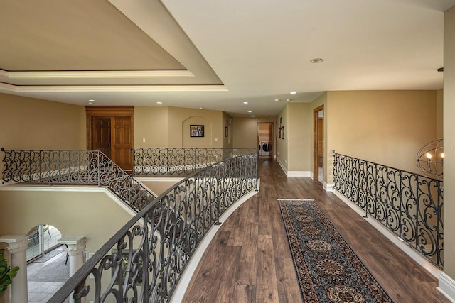 18290 Prairie Falcon Ln, Brookfield, WI 53045 - hallway featuring an upstairs landing, recessed lighting, wood finished floors, baseboards, and a tray ceiling