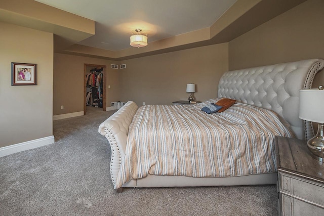 18290 Prairie Falcon Ln, Brookfield, WI 53045 - bedroom with carpet, baseboards, a tray ceiling, and a walk in closet