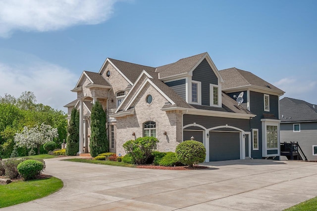 18290 Prairie Falcon Ln, Brookfield, WI 53045 - french provincial home with concrete driveway, an attached garage, brick siding, and roof with shingles