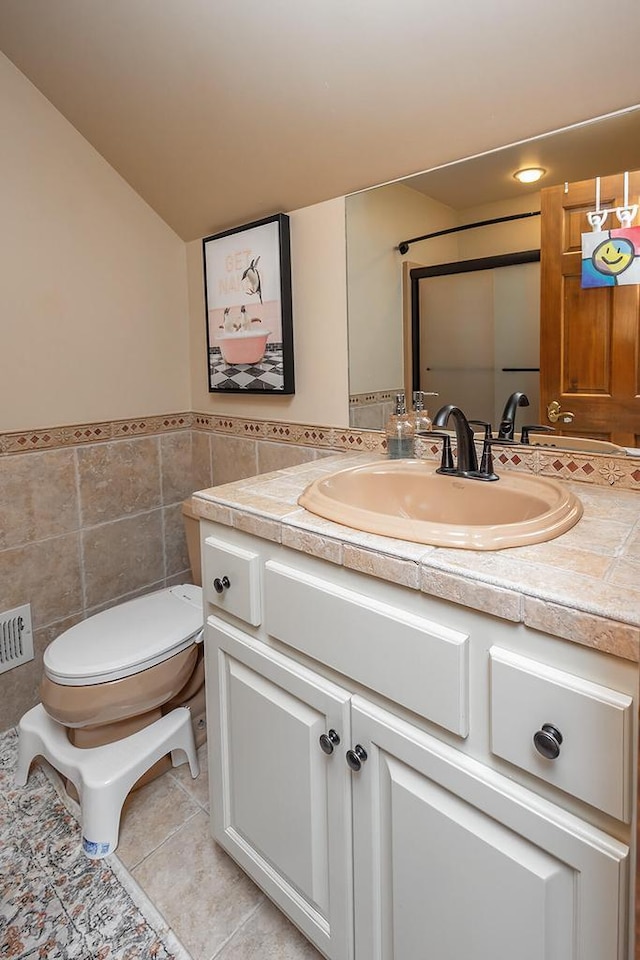 18290 Prairie Falcon Ln, Brookfield, WI 53045 - bathroom with vanity, tile walls, toilet, tile patterned flooring, and wainscoting