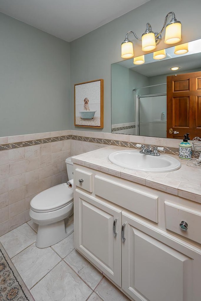 18290 Prairie Falcon Ln, Brookfield, WI 53045 - bathroom with vanity, toilet, an enclosed shower, marble look tile flooring, and a wainscoted wall