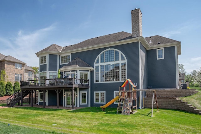 18290 Prairie Falcon Ln, Brookfield, WI 53045 - back of house featuring stairway, a wooden deck, a lawn, a chimney, and a playground