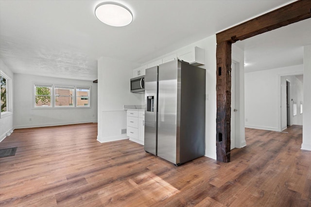 10104 Washington Ave, Mount Pleasant, WI 53177 - kitchen featuring appliances with stainless steel finishes, wood finished floors, white cabinets, light countertops, and baseboards