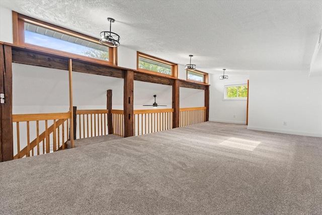 10104 Washington Ave, Mount Pleasant, WI 53177 - spare room featuring ceiling fan, carpet, baseboards, and a textured ceiling