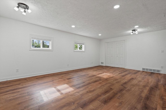 10104 Washington Ave, Mount Pleasant, WI 53177 - spare room with a textured ceiling, wood finished floors, recessed lighting, and baseboards