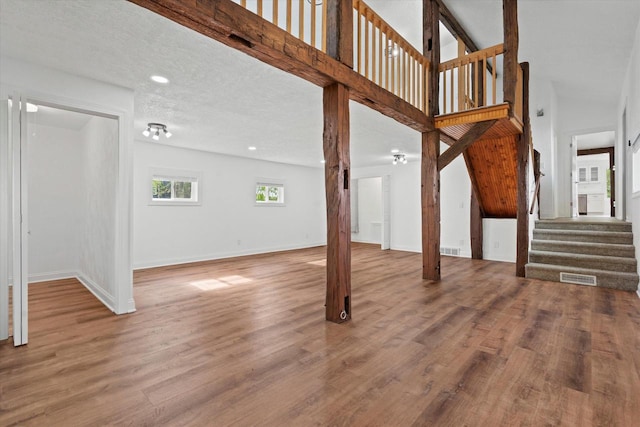 10104 Washington Ave, Mount Pleasant, WI 53177 - unfurnished living room featuring stairway, wood finished floors, baseboards, and recessed lighting