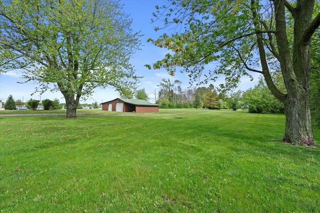 10104 Washington Ave, Mount Pleasant, WI 53177 - view of green lawn featuring a detached garage, an outbuilding, and a pole building