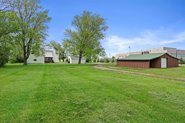 10104 Washington Ave, Mount Pleasant, WI 53177 - view of green lawn featuring an outdoor structure and a garage