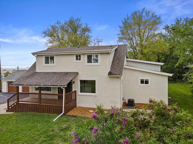 10104 Washington Ave, Mount Pleasant, WI 53177 - rear view of house with a shingled roof, stucco siding, a yard, and central air condition unit