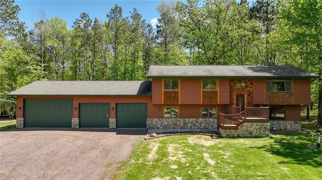 3015 Aspen Ter, Danbury, WI 54830 - view of front of property featuring asphalt driveway, stone siding, and a front yard