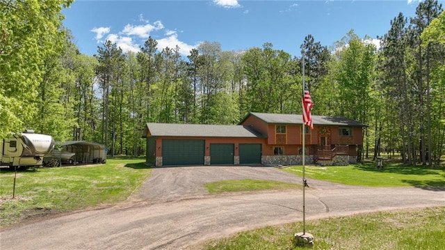 3015 Aspen Ter, Danbury, WI 54830 - split foyer home featuring driveway, an attached garage, a front lawn, and stone siding